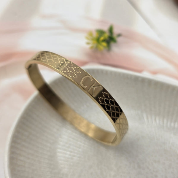 Gold-tone bangle bracelet.