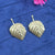 gold-toned, leaf-shaped stud earrings.