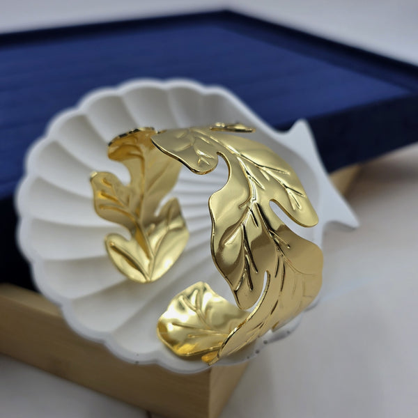 gold-tone cuff bracelet leaf motif.