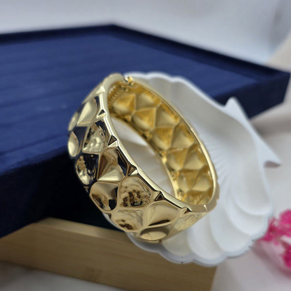 gold-toned metal architectural stylebracelet