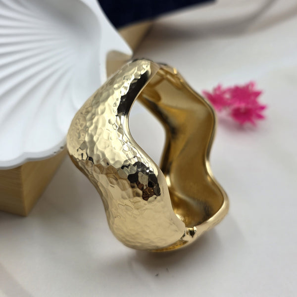 chunky, modern gold-toned bracelet