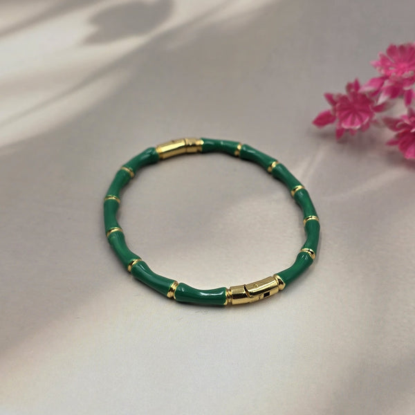 gold-toned bamboo-link design bracelet.