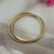 polished gold-tone metal bangle bracelet