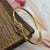 oval-shaped gold-toned bangle